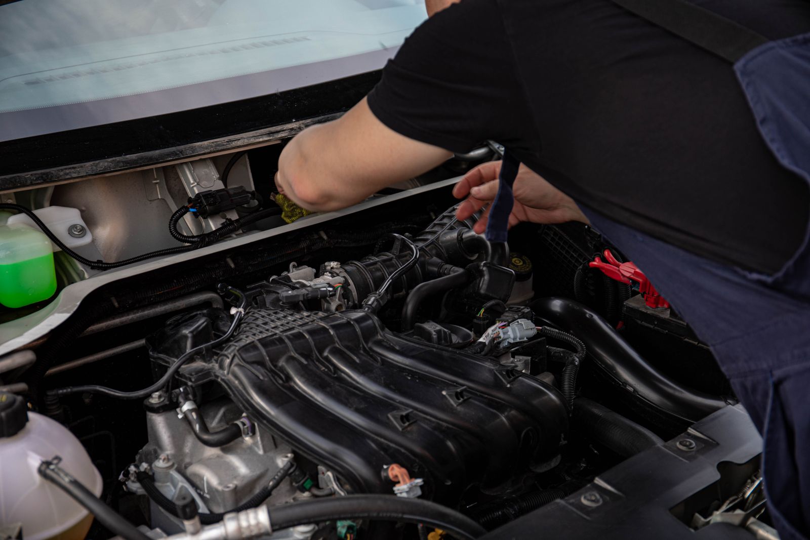 Technician inspecting under the hood