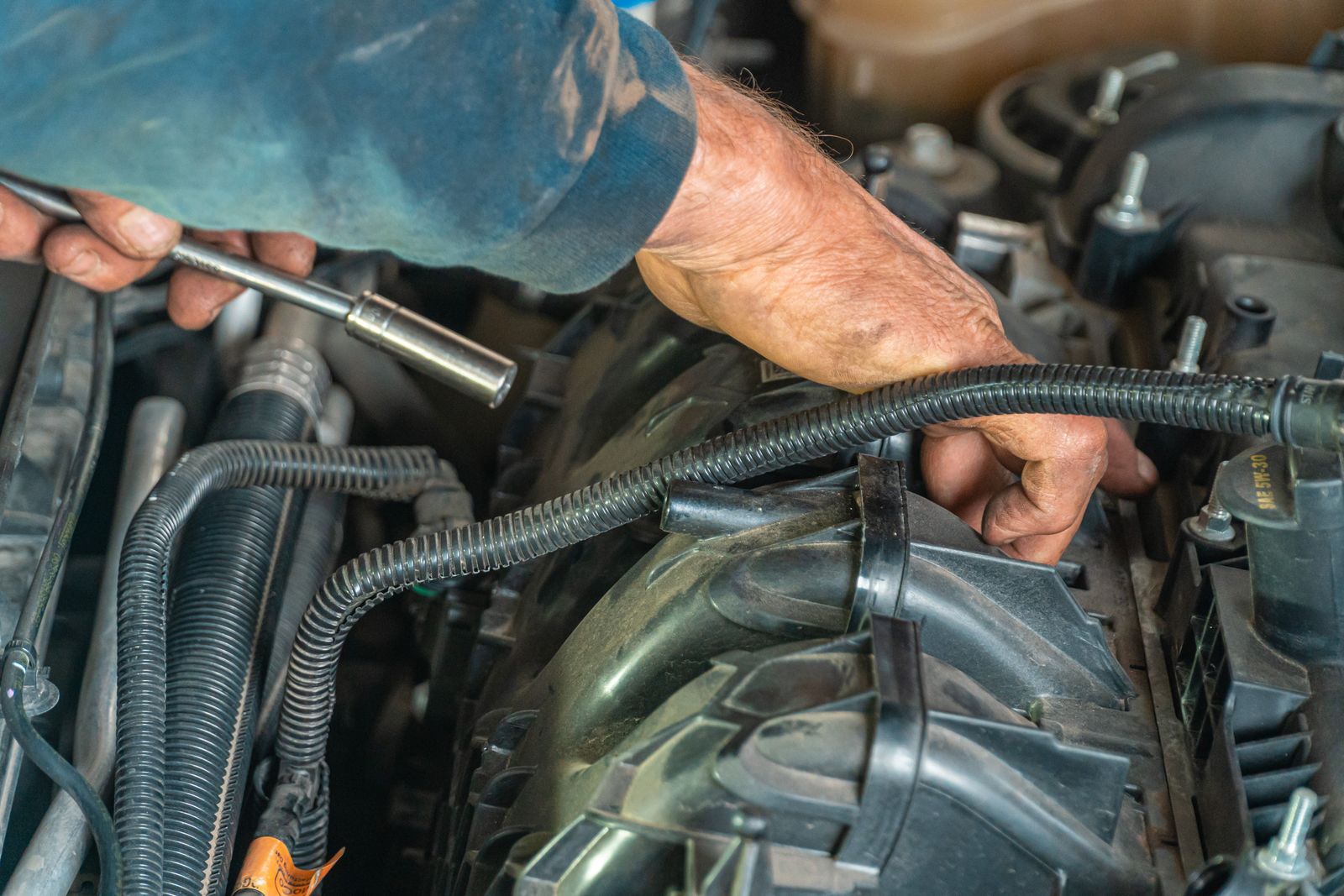 Close-up of engine repair with hand tools